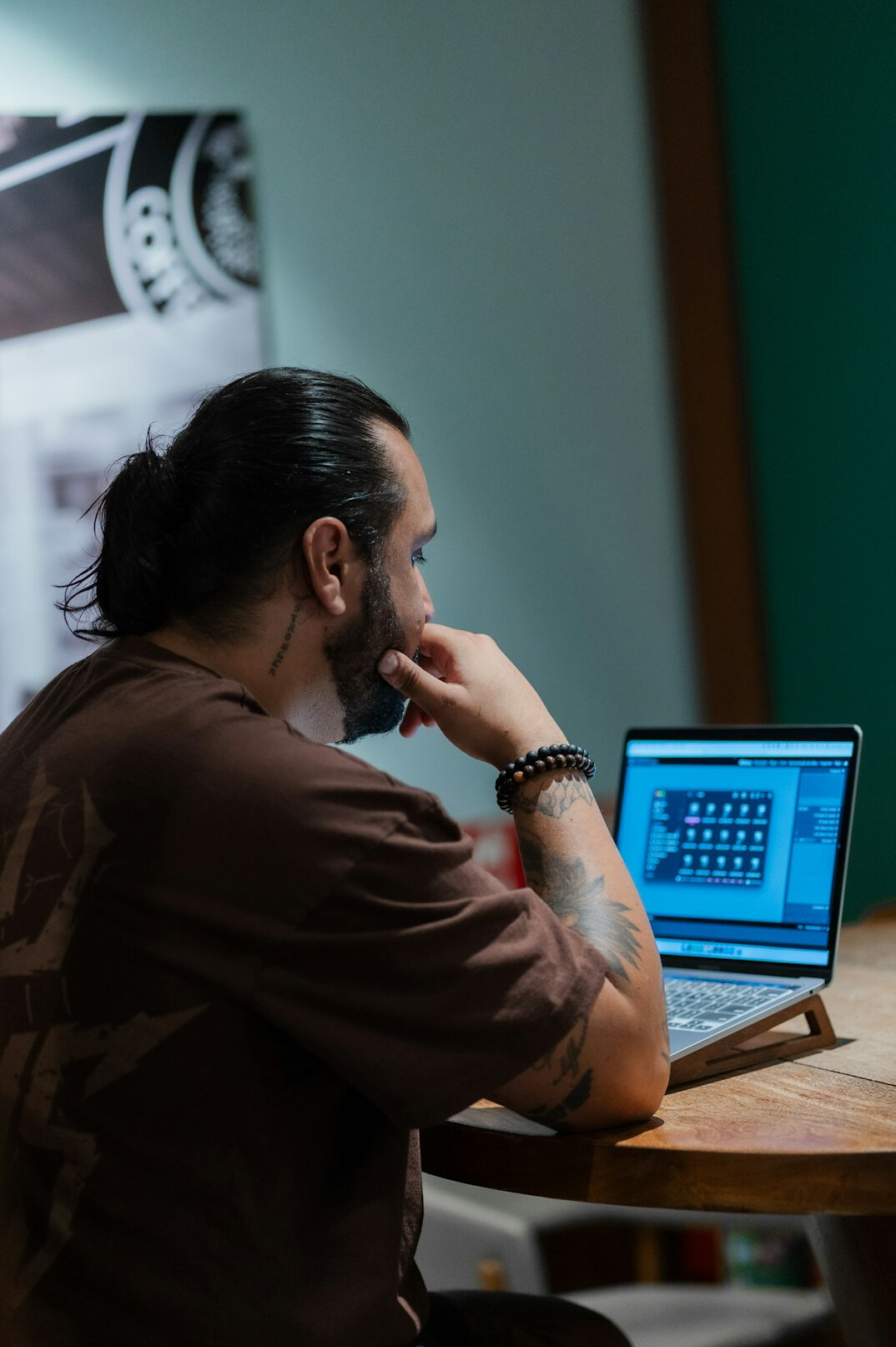 young man coding on laptop
