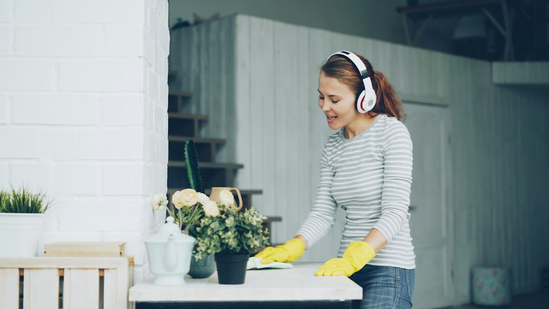 Woman with headphones learning online on a laptop