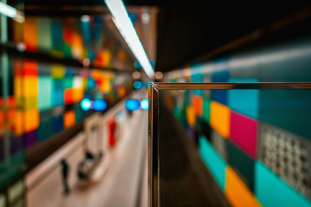 Colourful sticky notes with programming concepts on a glass wall
