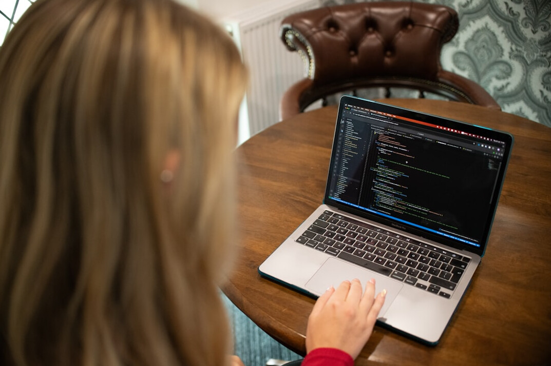 young programmer coding on laptop