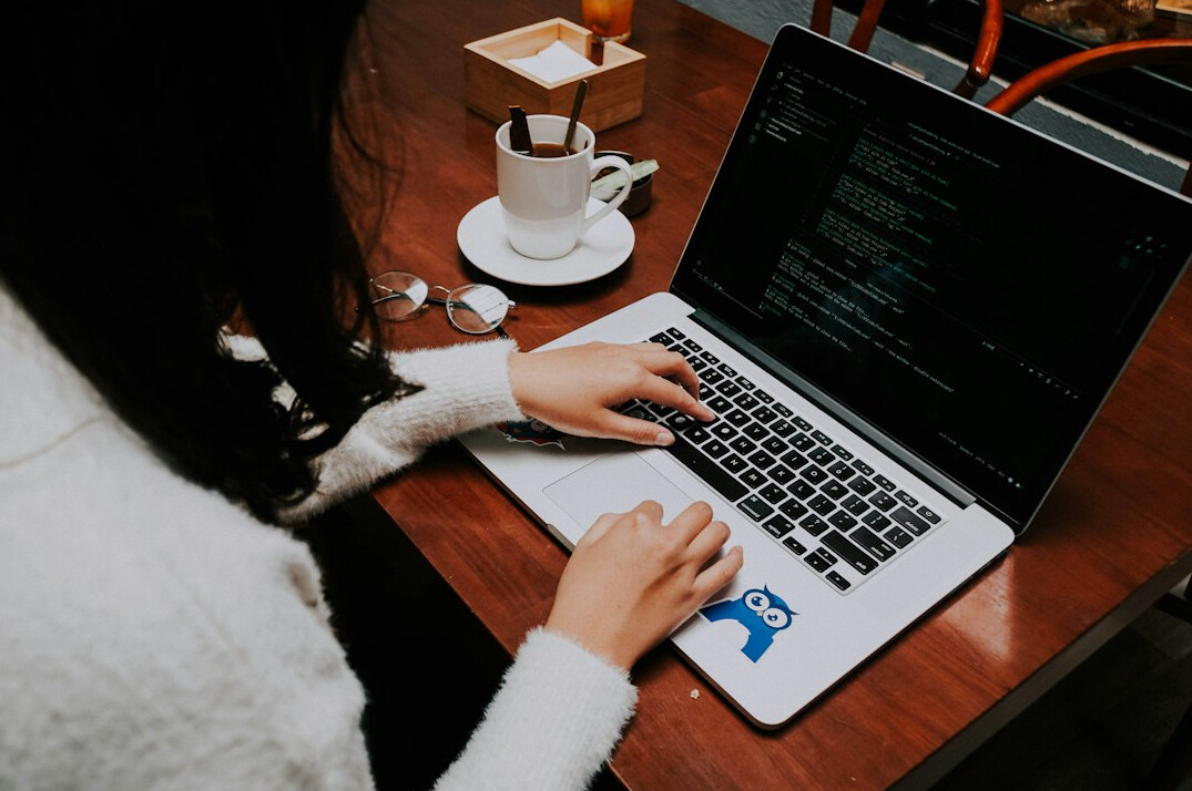 young programmer coding on laptop